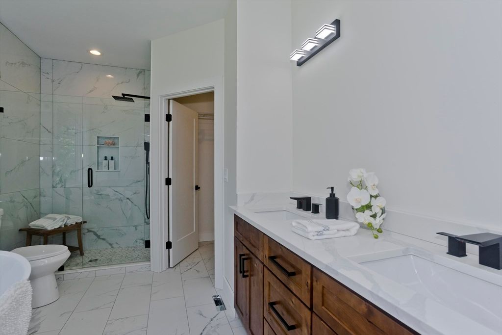 Bathroom, Dual Sink Vanities, Glass Shower, Interior, Marble, Marble Walls, Recessed Lighting