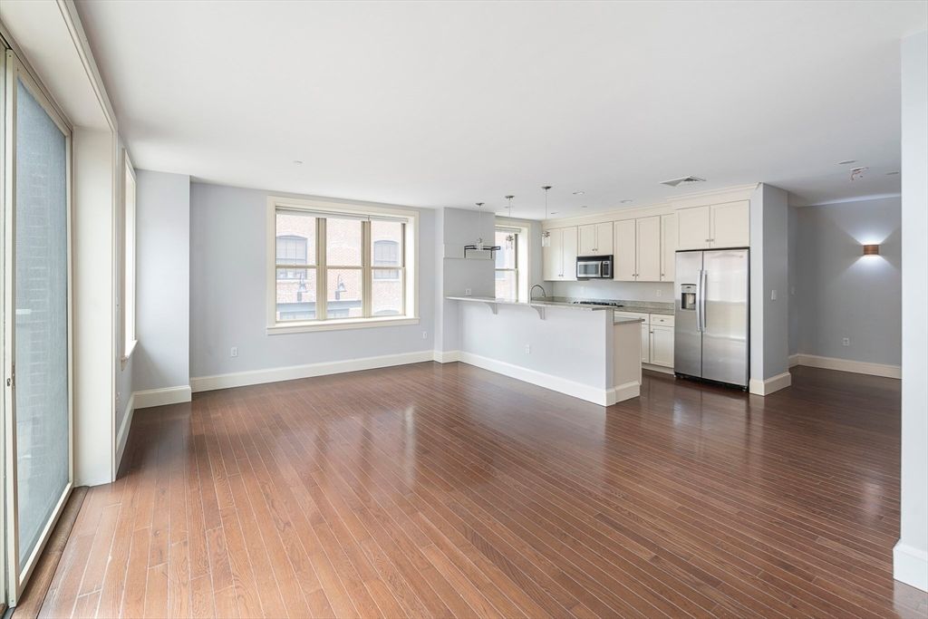 Empty room, Interior, Kitchen, Pendant Lights, Stainless Steel Appliances, Wood Texture Flooring