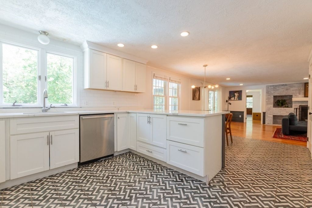 Fireplace, Interior, Kitchen, Pendant Lights, Recessed Lighting, Stainless Steel Appliances, Stone Walls, Wood Texture Flooring