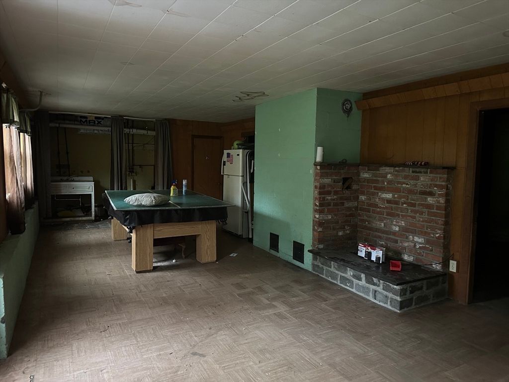 Fireplace, Game Room, Interior, Stone Walls, Wood Texture Flooring