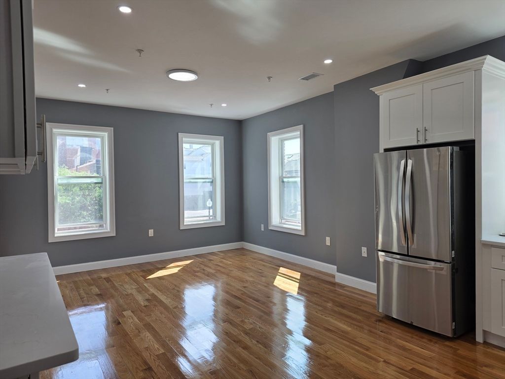 Empty room, Interior, Kitchen, Recessed Lighting, Stainless Steel Appliances, Wood Texture Flooring
