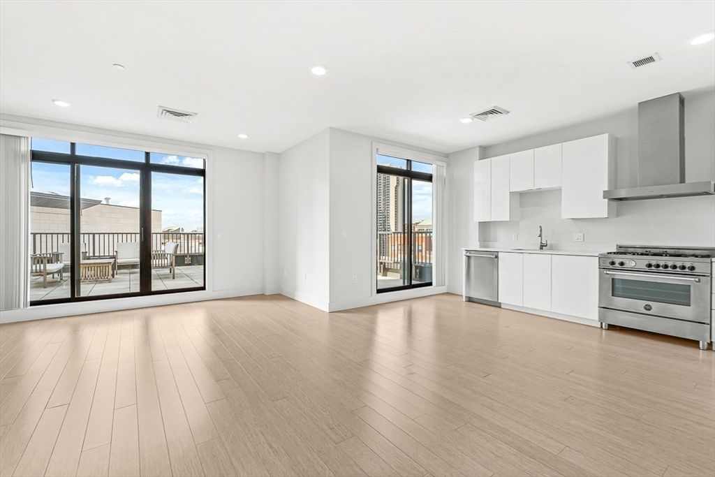 Empty room, Interior, Kitchen, Recessed Lighting, Stainless Steel Appliances, Water, Wood Texture Flooring