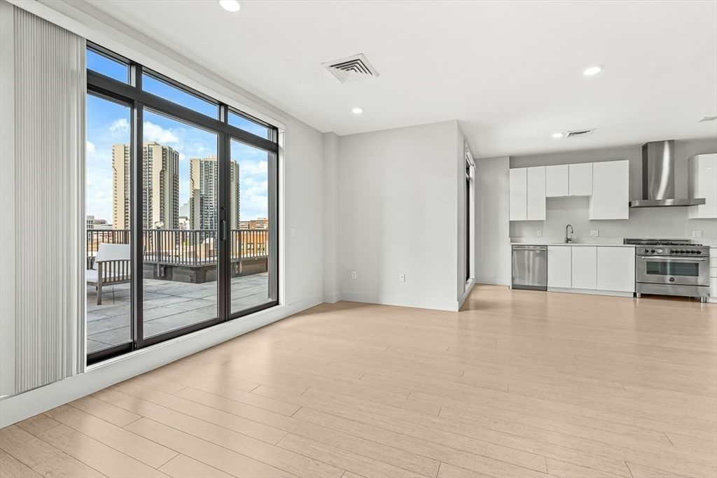 Empty room, Interior, Kitchen, Recessed Lighting, Stainless Steel Appliances, Wood Texture Flooring