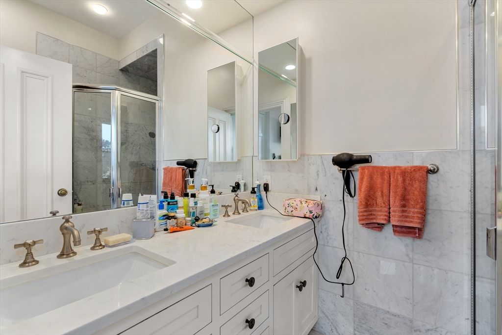 Bathroom, Dual Sink Vanities, Glass Shower, Interior, Marble, Marble Walls, Recessed Lighting