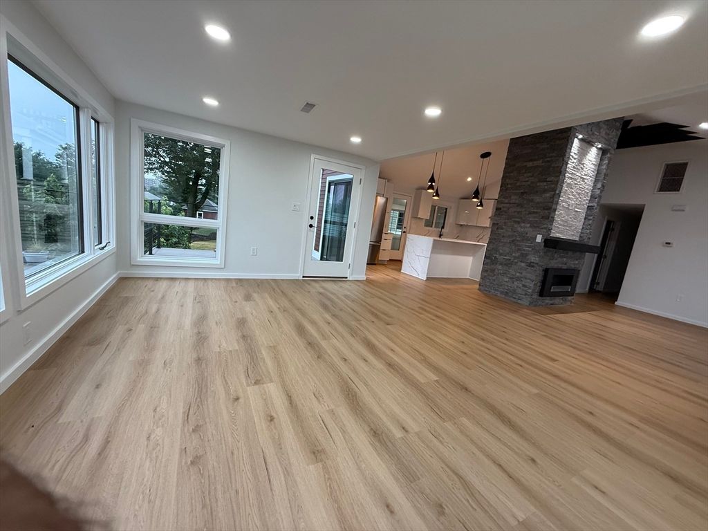 Empty room, Fireplace, Interior, Kitchen, Pendant Lights, Recessed Lighting, Wood Texture Flooring