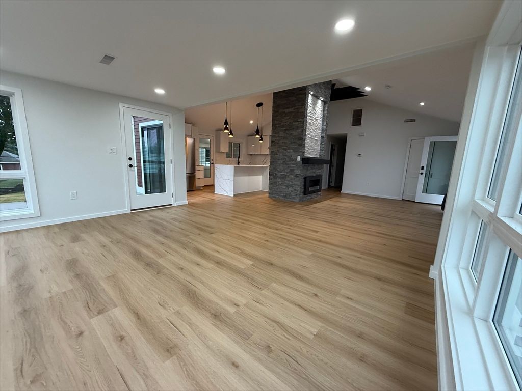 Empty room, Fireplace, Interior, Kitchen, Pendant Lights, Recessed Lighting, Stone Walls, Wood Texture Flooring