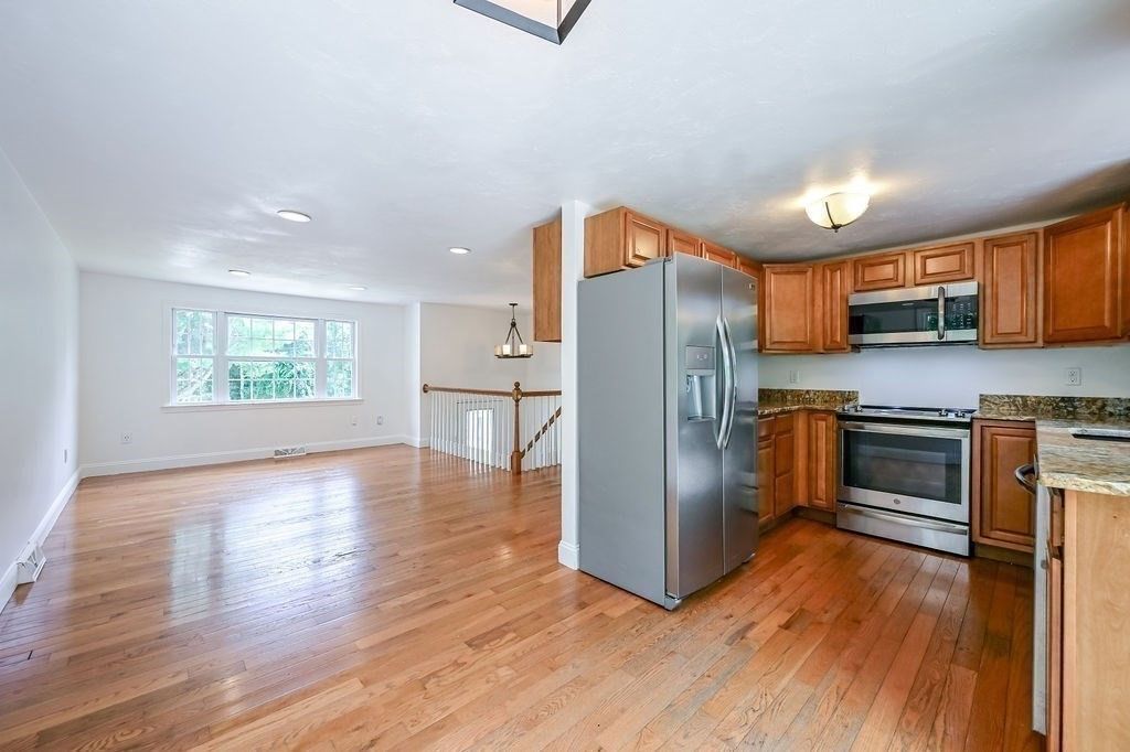 Empty room, Interior, Kitchen, Pendant Lights, Recessed Lighting, Stainless Steel Appliances, Wood Texture Flooring