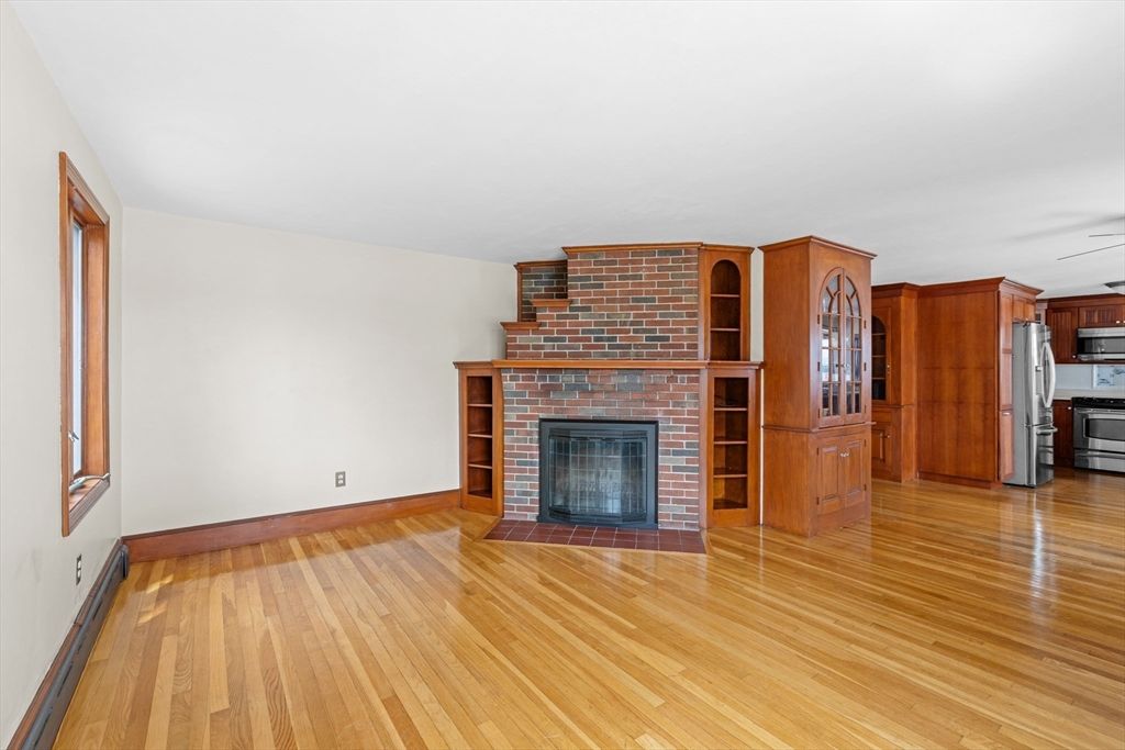 Empty room, Fireplace, Interior, Kitchen, Stainless Steel Appliances, Stone Walls, Wood Texture Flooring