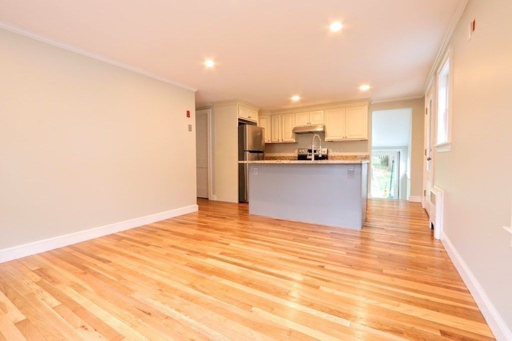 Empty room, Interior, Kitchen, Recessed Lighting, Stainless Steel Appliances, Wood Texture Flooring