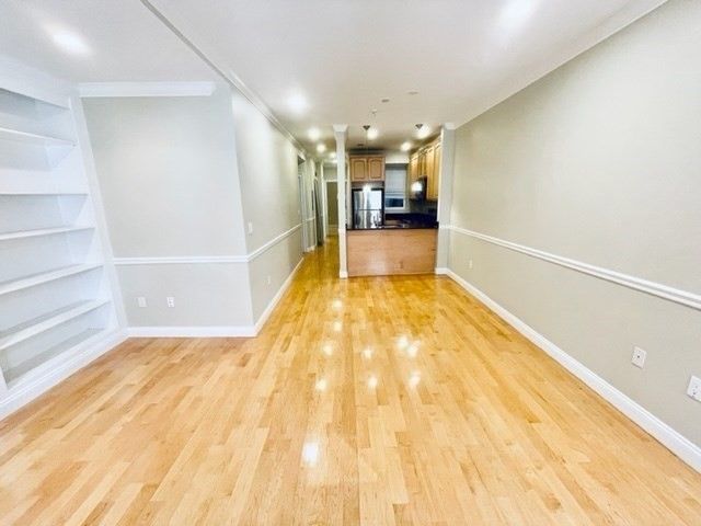 Empty room, Interior, Kitchen, Recessed Lighting, Stainless Steel Appliances, Wood Texture Flooring