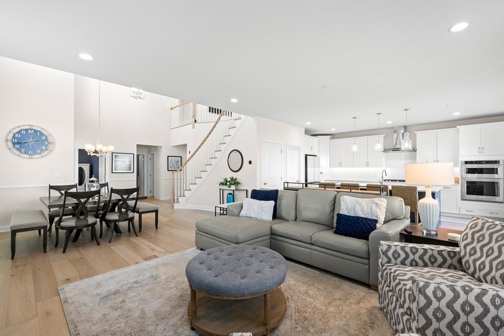 Chandelier, Dining room, Interior, Kitchen, Living room, Pendant Lights, Recessed Lighting, Stainless Steel Appliances, Wood Texture Flooring