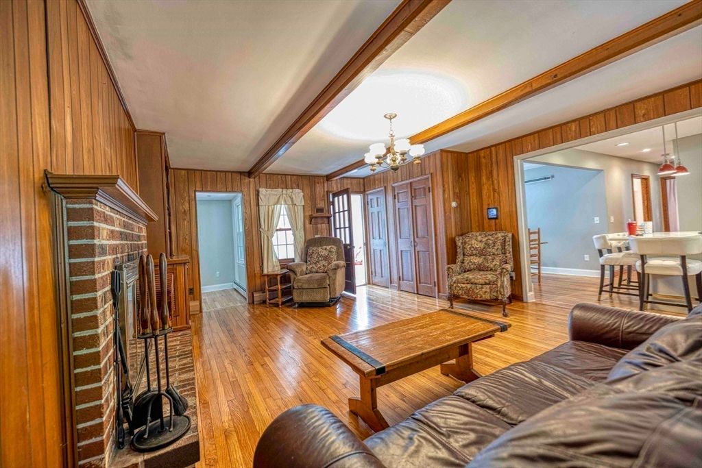 Chandelier, Dining room, Fireplace, Interior, Living room, Recessed Lighting, Wood Texture Flooring, Wooden Walls