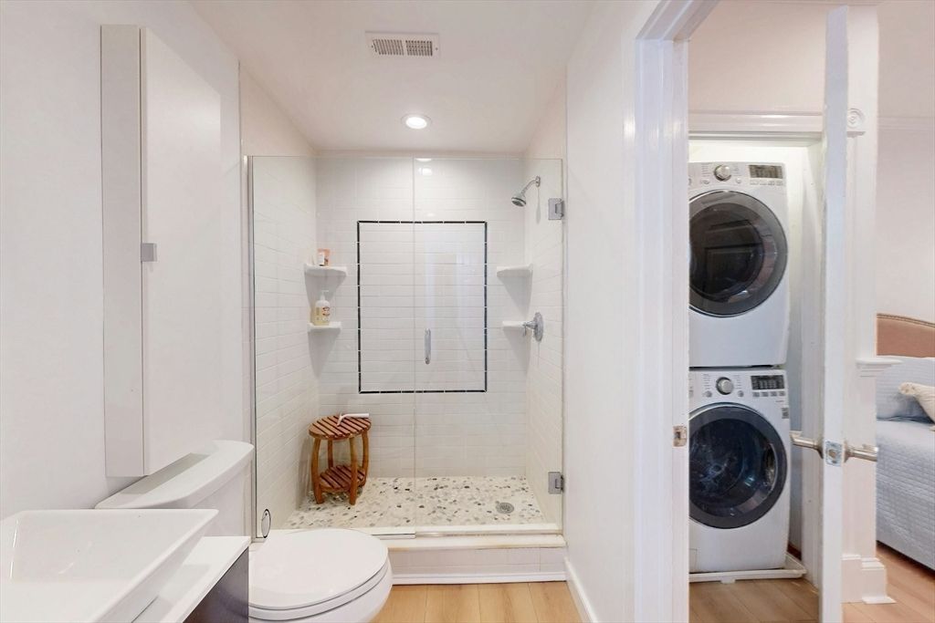 Bathroom, Glass Shower, Interior, Recessed Lighting, Utility Closets, Washer, Wood Texture Flooring
