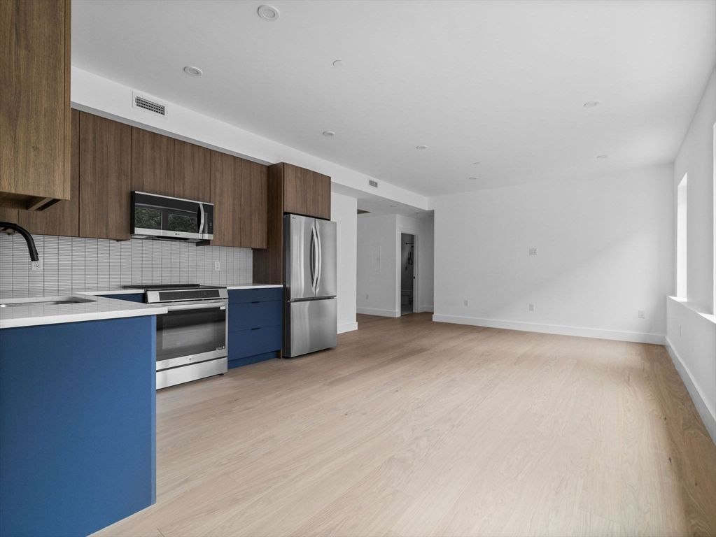 Interior, Kitchen, Recessed Lighting, Stainless Steel Appliances, Tile Countertops, Wood Texture Flooring