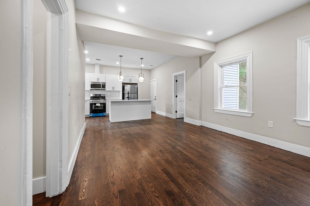 Empty room, Interior, Kitchen, Pendant Lights, Recessed Lighting, Stainless Steel Appliances, Wood Texture Flooring
