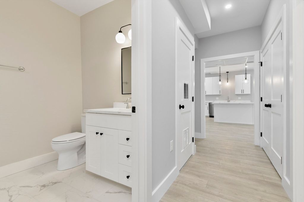 Bathroom, Dual Sink Vanities, Interior, Marble, Pendant Lights, Recessed Lighting, Wood Texture Flooring