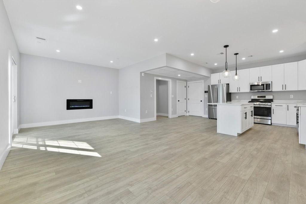 Empty room, Interior, Kitchen, Pendant Lights, Recessed Lighting, Stainless Steel Appliances, Wood Texture Flooring