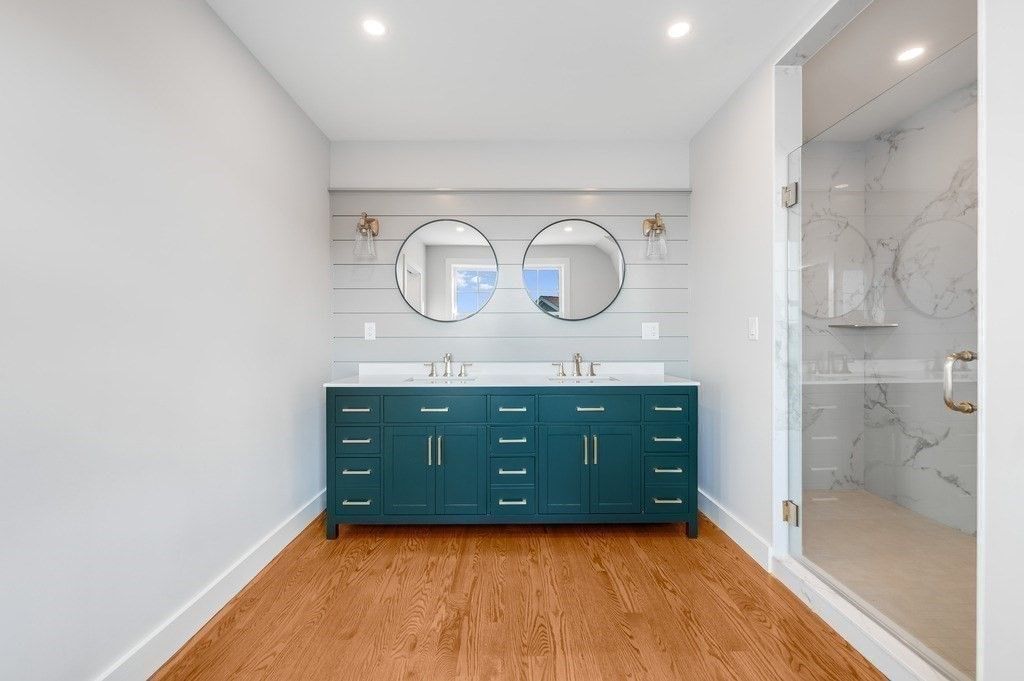 Bathroom, Dual Sink Vanities, Interior, Marble Walls, Recessed Lighting, Wood Texture Flooring