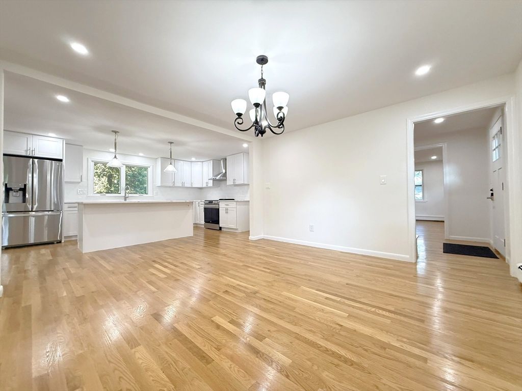 Chandelier, Empty room, Interior, Kitchen, Pendant Lights, Recessed Lighting, Stainless Steel Appliances, Wood Texture Flooring