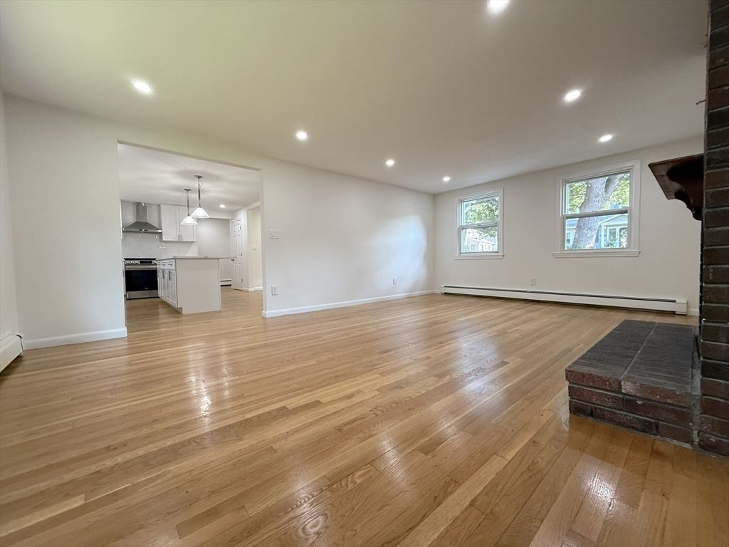 Empty room, Interior, Kitchen, Pendant Lights, Recessed Lighting, Stainless Steel Appliances, Wood Texture Flooring