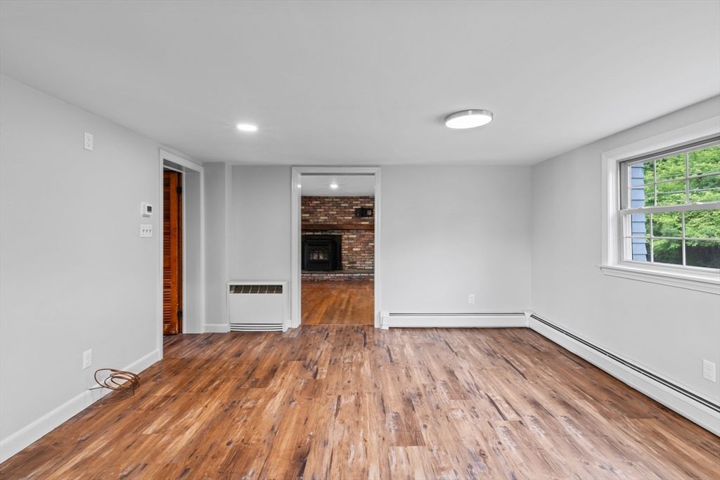 Empty room, Fireplace, Interior, Recessed Lighting, Stone Walls, Wood Texture Flooring
