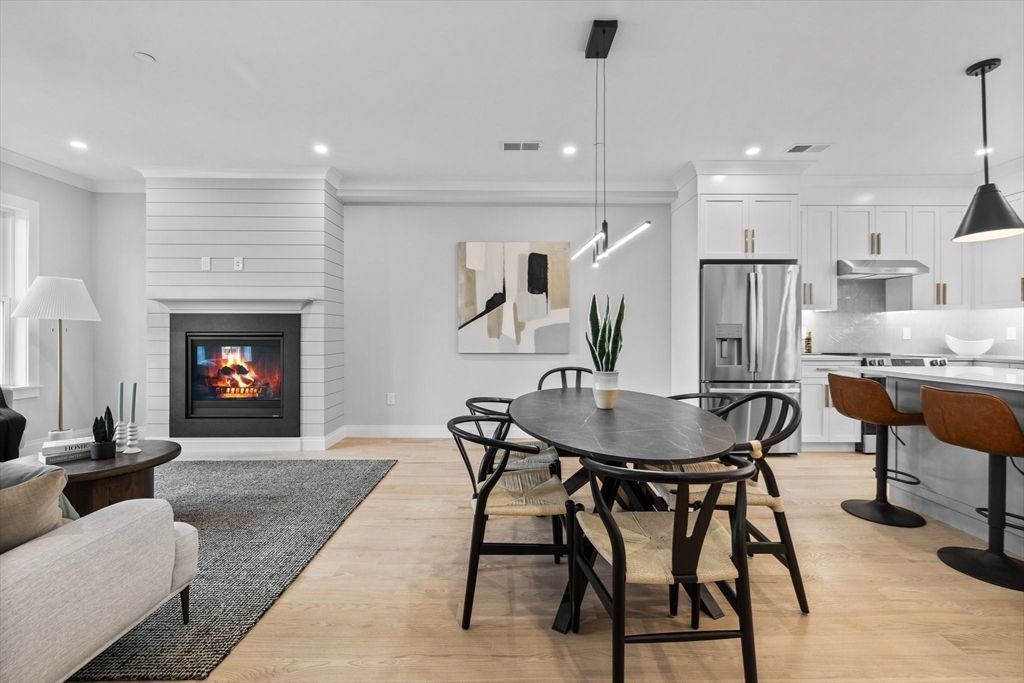Dining room, Fireplace, Interior, Kitchen, Pendant Lights, Recessed Lighting, Stainless Steel Appliances, Wood Texture Flooring