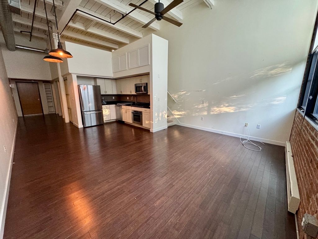 Empty room, Interior, Kitchen, Pendant Lights, Stainless Steel Appliances, Stone Walls, Wooden Beams, Wood Texture Flooring