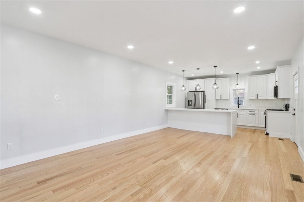 Empty room, Interior, Kitchen, Pendant Lights, Recessed Lighting, Stainless Steel Appliances, Wood Texture Flooring