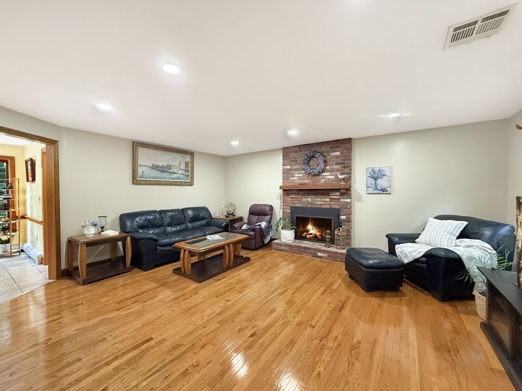 Fireplace, Interior, Living room, Recessed Lighting, Stone Walls, Wood Texture Flooring