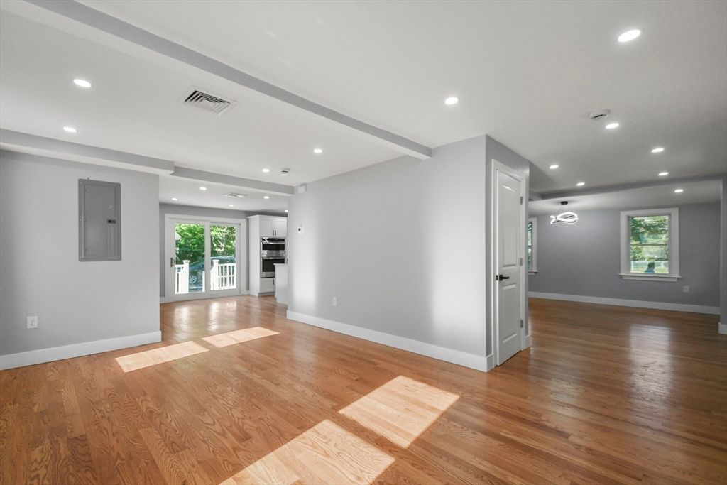 Empty room, Interior, Kitchen, Recessed Lighting, Stainless Steel Appliances, Wood Texture Flooring