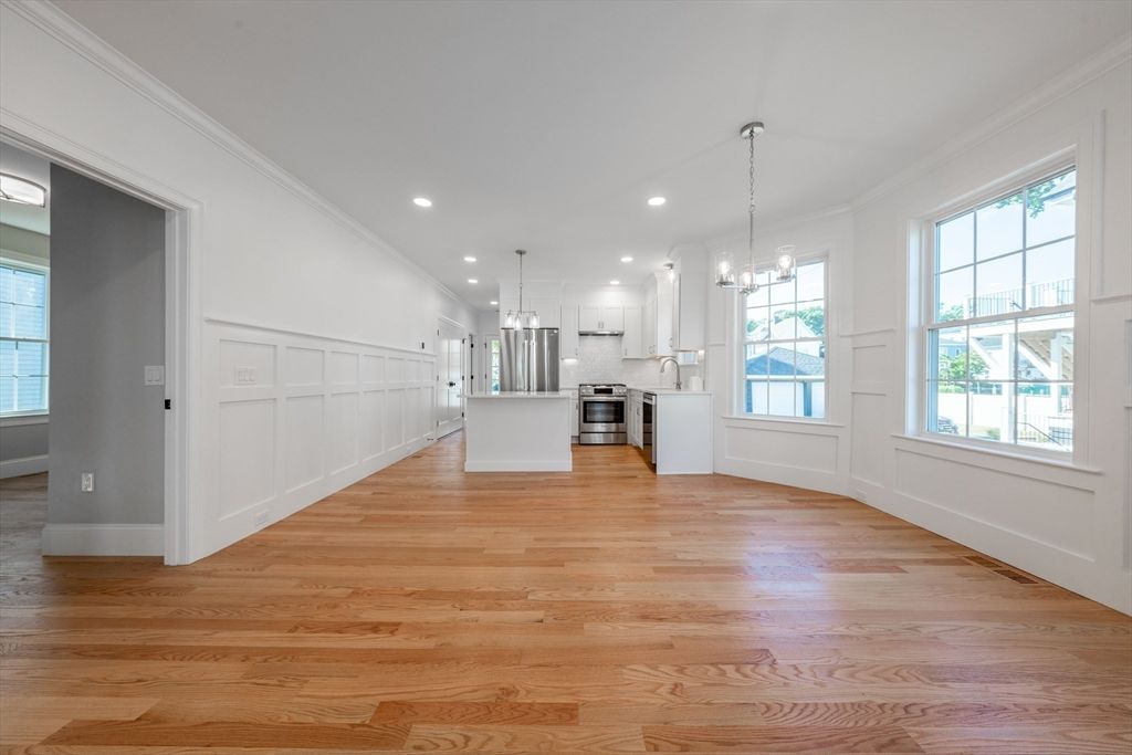 Empty room, Interior, Kitchen, Pendant Lights, Recessed Lighting, Stainless Steel Appliances, Wood Texture Flooring