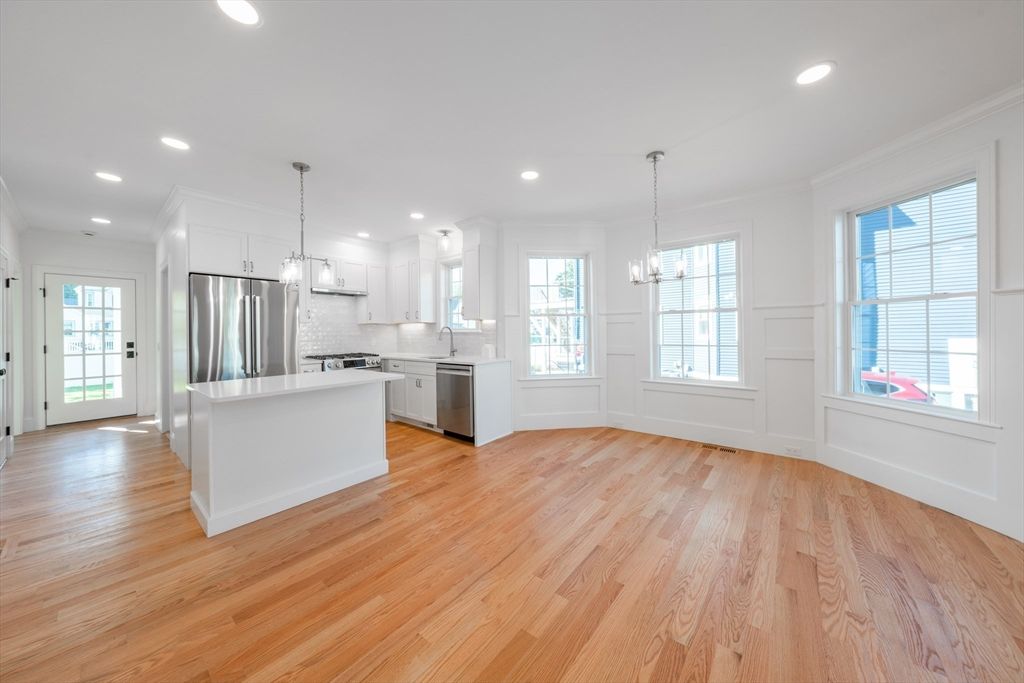 Chandelier, Empty room, Interior, Kitchen, Pendant Lights, Recessed Lighting, Stainless Steel Appliances, Wood Texture Flooring