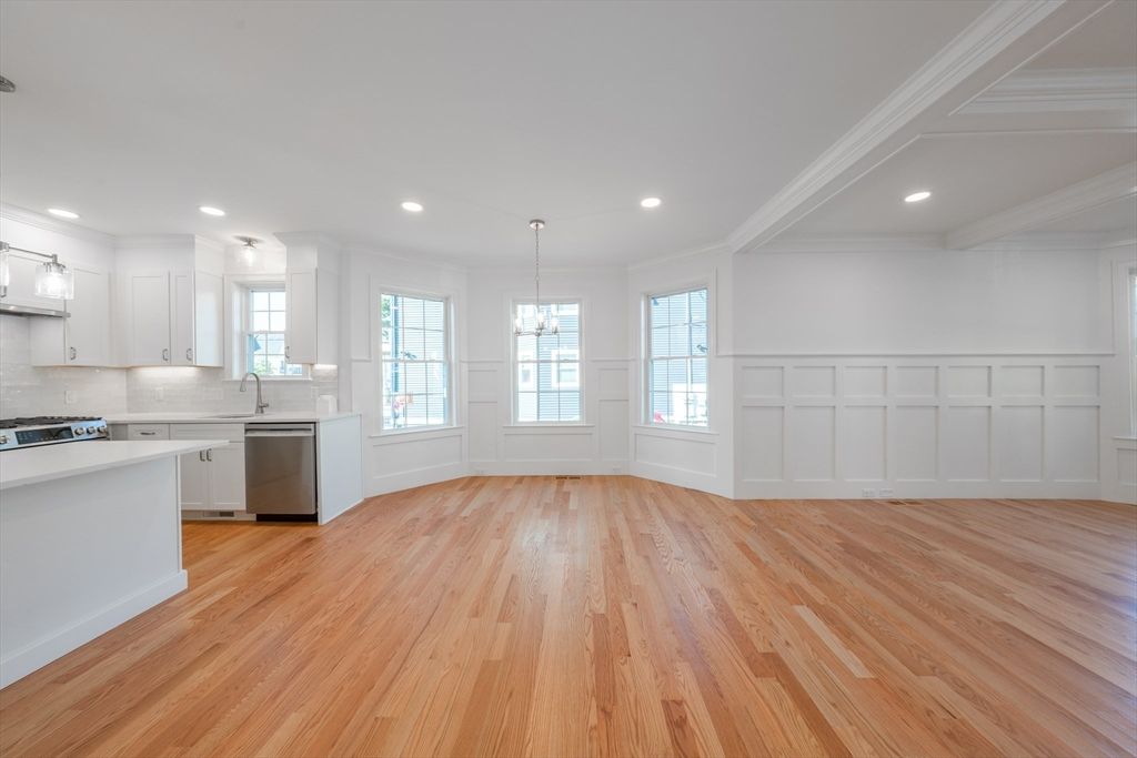 Empty room, Interior, Kitchen, Pendant Lights, Recessed Lighting, Stainless Steel Appliances, Wood Texture Flooring