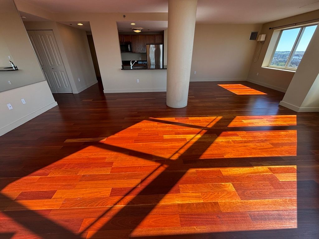 Empty room, Interior, Kitchen, Recessed Lighting, Stainless Steel Appliances, Wood Texture Flooring