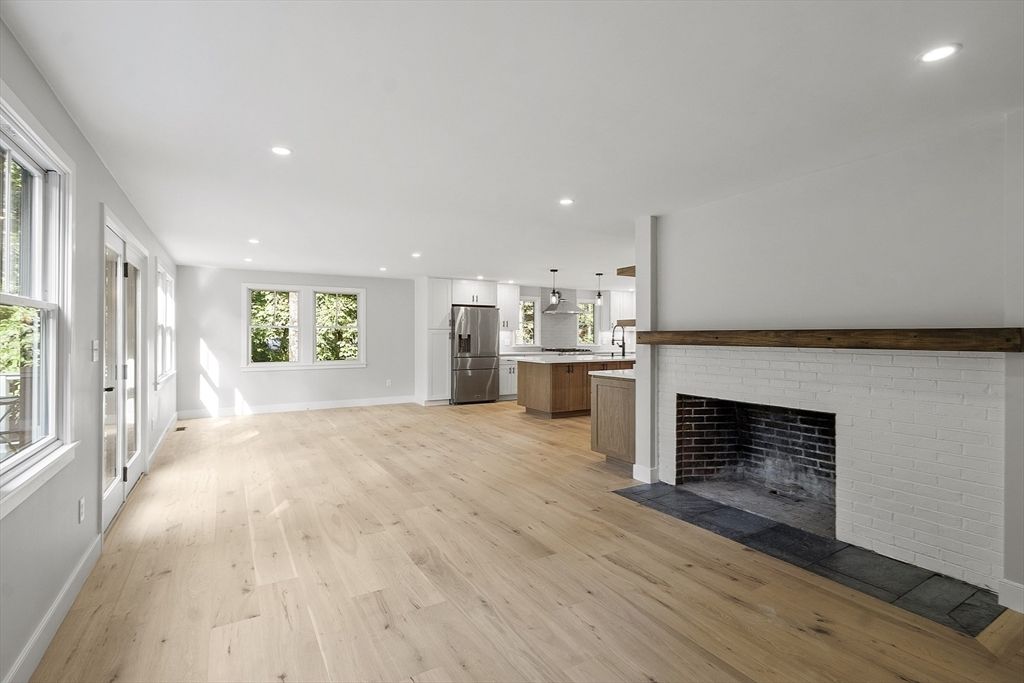 Empty room, Fireplace, Interior, Kitchen, Pendant Lights, Recessed Lighting, Stainless Steel Appliances, Stone Walls, Wood Texture Flooring