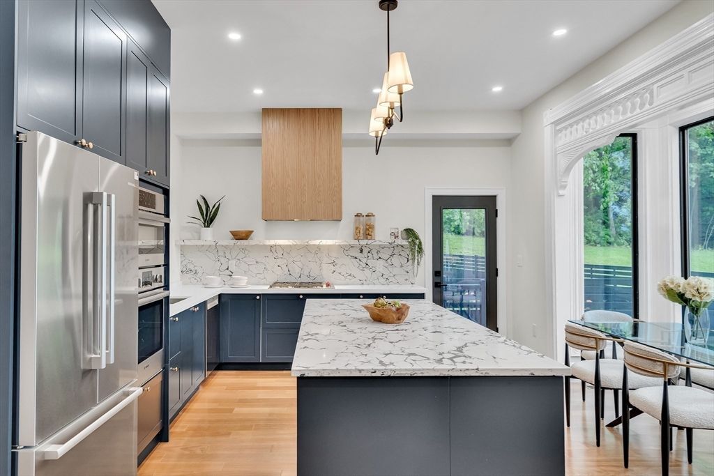 Interior, Kitchen, Marble Walls, Pendant Lights, Recessed Lighting, Stainless Steel Appliances, Wood Texture Flooring