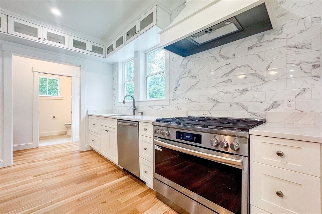 Interior, Kitchen, Marble Walls, Recessed Lighting, Stainless Steel Appliances, Wood Texture Flooring
