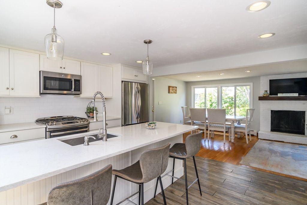 Dining room, Fireplace, Interior, Kitchen, Pendant Lights, Recessed Lighting, Stainless Steel Appliances, Wood Texture Flooring