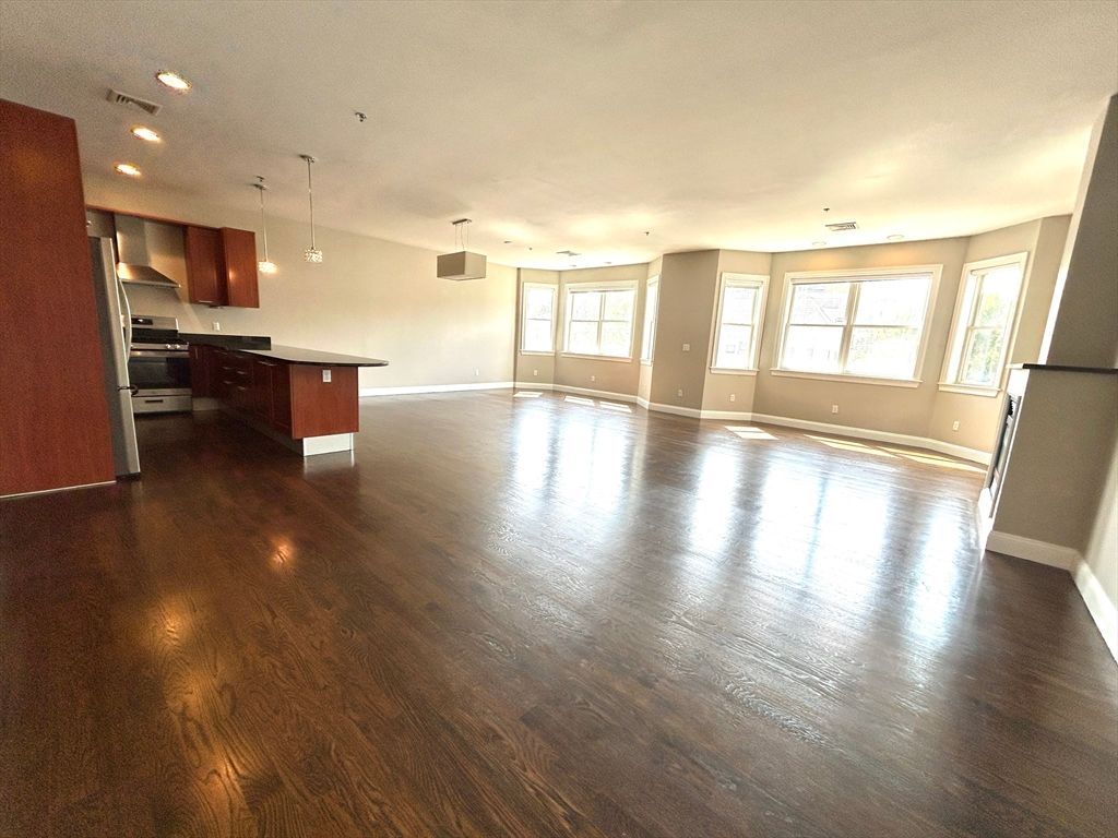 Empty room, Interior, Kitchen, Pendant Lights, Recessed Lighting, Stainless Steel Appliances, Wood Texture Flooring