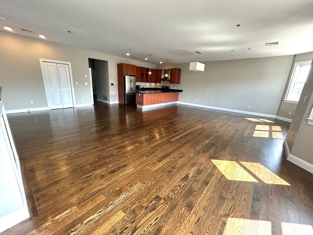 Empty room, Interior, Kitchen, Pendant Lights, Recessed Lighting, Stainless Steel Appliances, Wood Texture Flooring