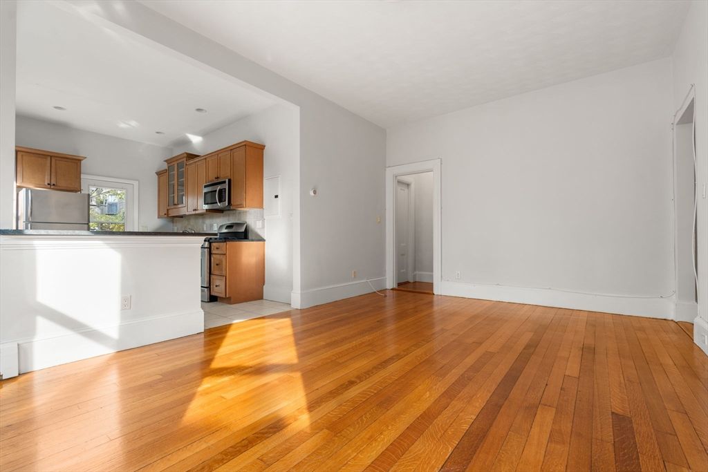 Empty room, Interior, Kitchen, Recessed Lighting, Stainless Steel Appliances, Wood Texture Flooring