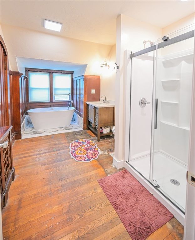 Bathroom, Free Standing Baths, Glass Shower, Interior, Recessed Lighting, Wood Texture Flooring