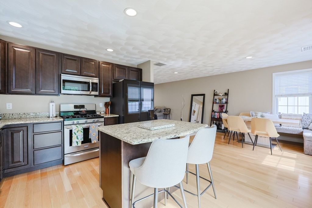 Dining room, Interior, Kitchen, Living room, Recessed Lighting, Stainless Steel Appliances, Wood Texture Flooring