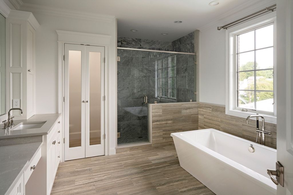 Bathroom, Free Standing Baths, Glass Shower, Interior, Marble Walls, Recessed Lighting, Wood Texture Flooring
