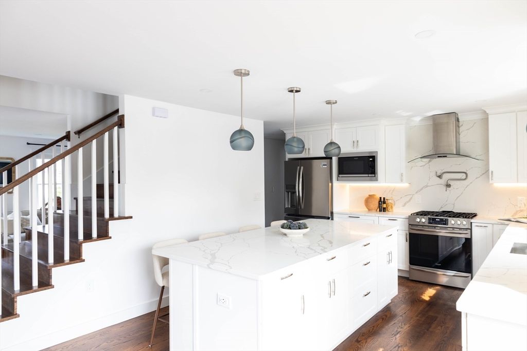 Interior, Kitchen, Marble Walls, Pendant Lights, Recessed Lighting, Stainless Steel Appliances, Wood Texture Flooring