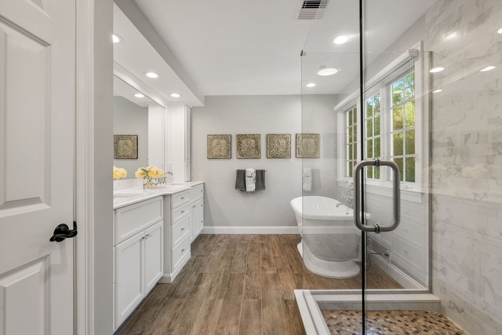 Bathroom, Dual Sink Vanities, Free Standing Baths, Glass Shower, Interior, Marble Walls, Recessed Lighting, Wood Texture Flooring