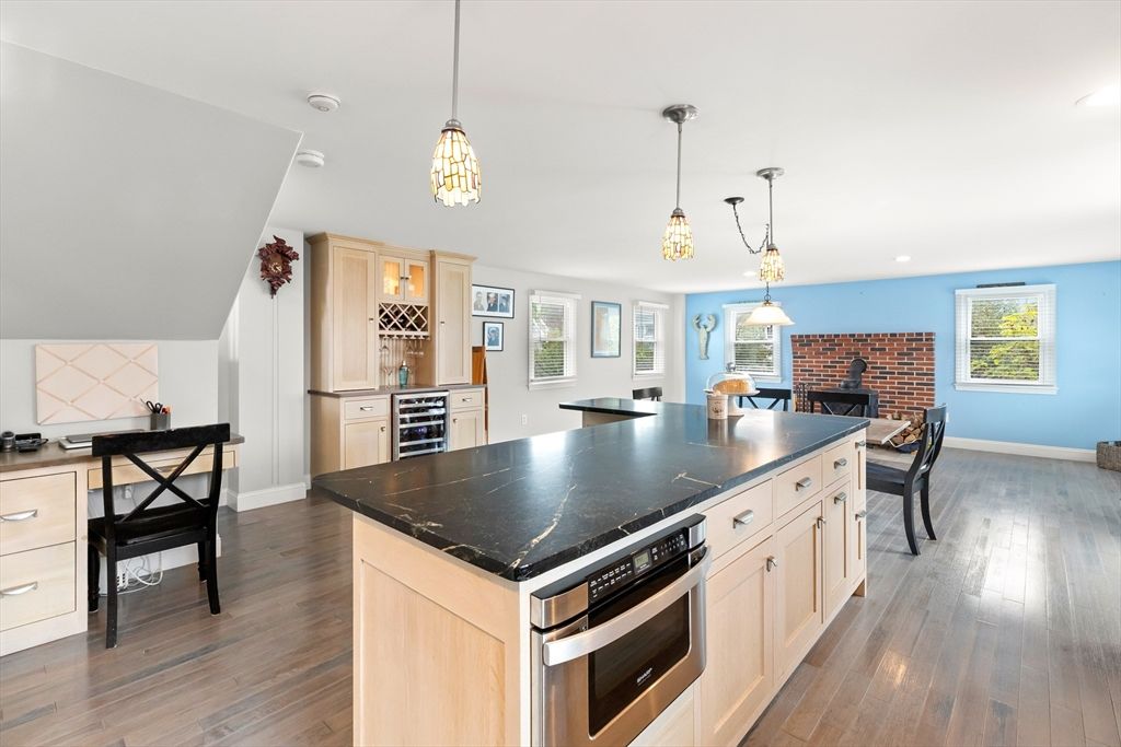 Dining room, Fireplace, Interior, Kitchen, Pendant Lights, Recessed Lighting, Stainless Steel Appliances, Stone Walls, Wood Texture Flooring