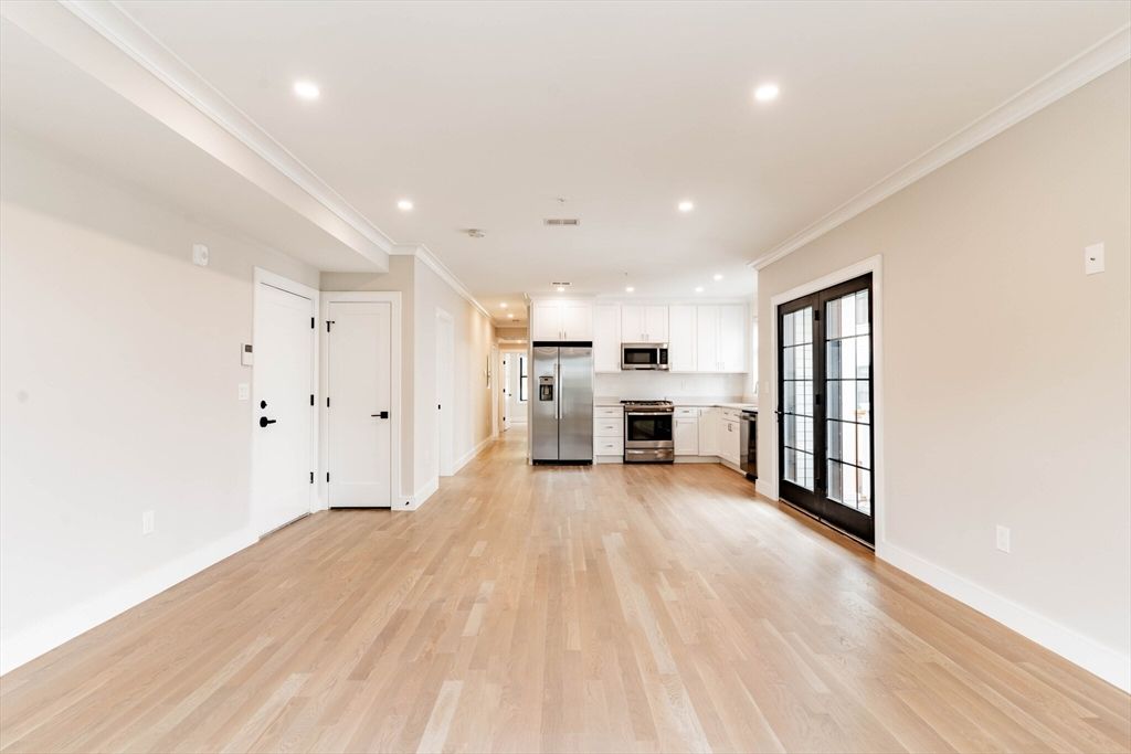 Empty room, Interior, Kitchen, Recessed Lighting, Stainless Steel Appliances, Wood Texture Flooring