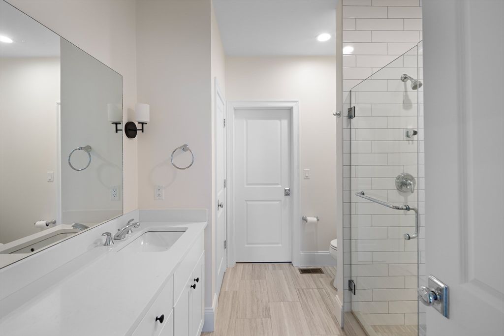 Bathroom, Dual Sink Vanities, Glass Shower, Interior, Recessed Lighting, Wood Texture Flooring