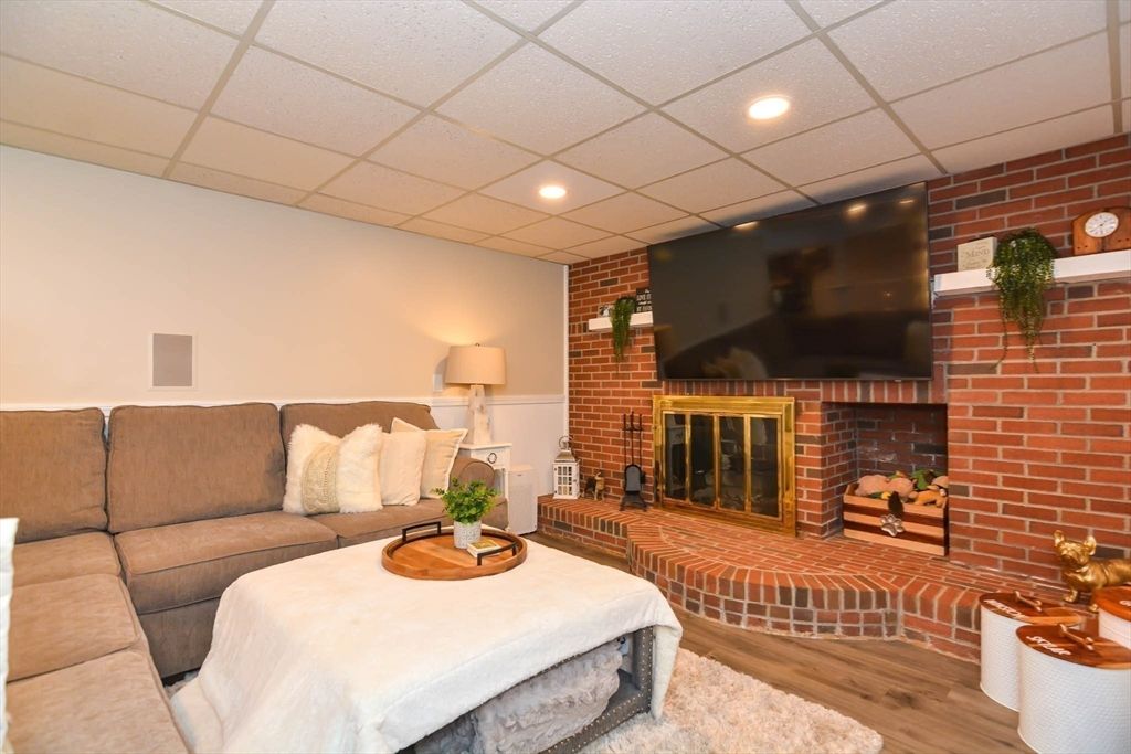 Fireplace, Interior, Living room, Recessed Lighting, Stone Walls, Wood Texture Flooring